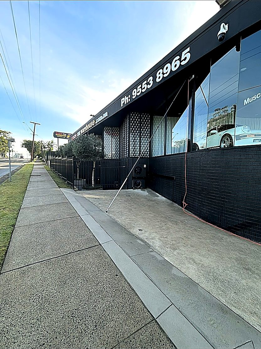 Commercial exterior cleaning — Muscle Car Warehouse frontage